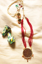 Load image into Gallery viewer, Intricately Detailed Gold Toned Pendant Necklace Set with Multi-Layer Red Beads Closure
