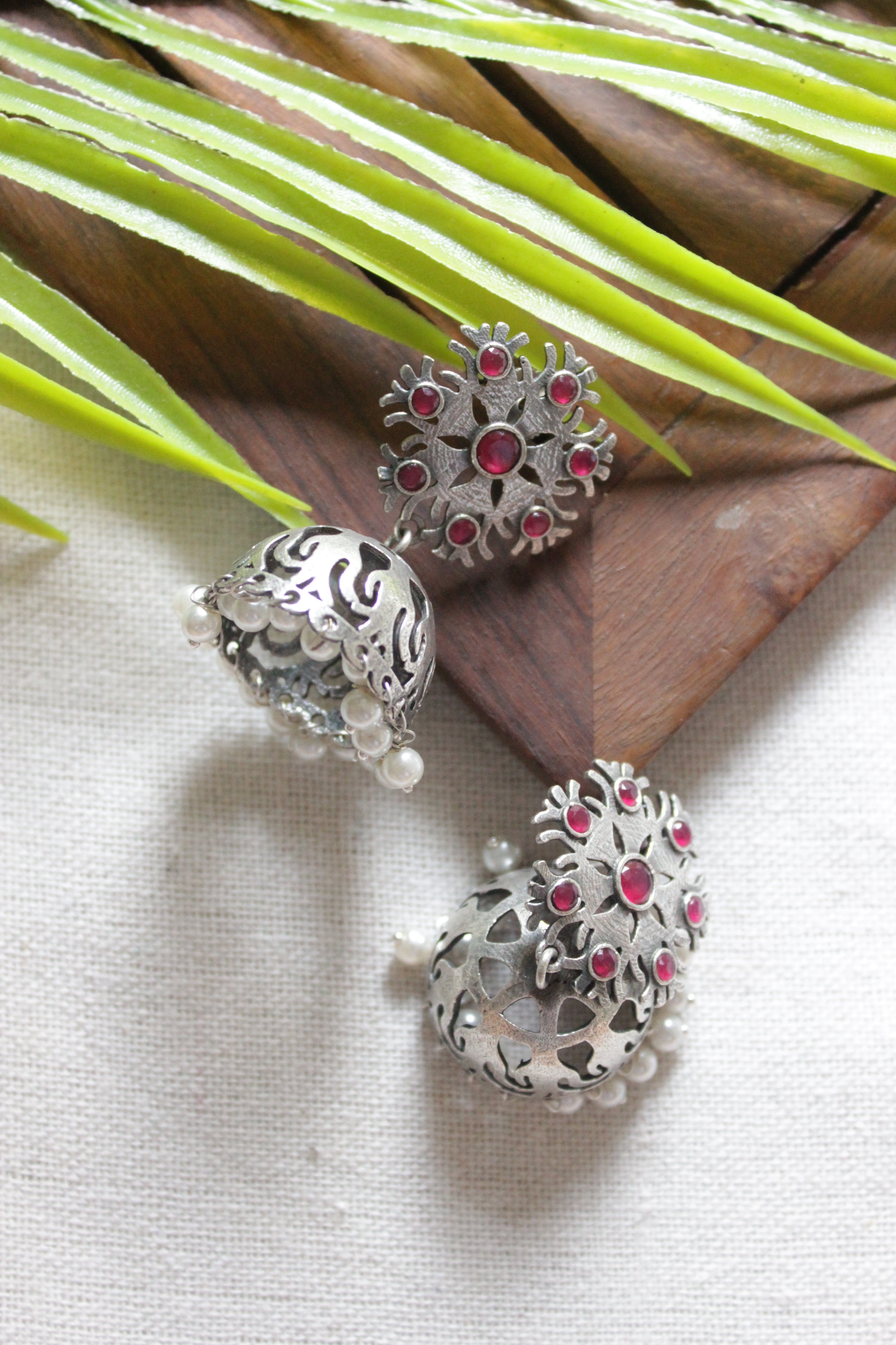 Fuchsia Glass Stones Embedded Jaali Pattern Premium Oxidised Finish Jhumka Earrings