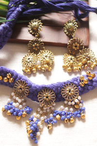 Purple Braided Threads Necklace Set Embellished with Antique Gold Finish Flower Motifs Metal Charms