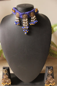 Purple Braided Threads Necklace Set Embellished with Antique Gold Finish Flower Motifs Metal Charms