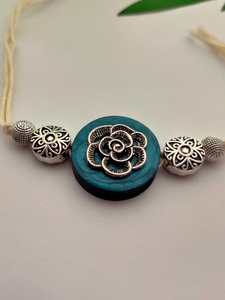 Intricately Detailed Blue Wood and Metal Rakhi with Off-White Cotton Thread