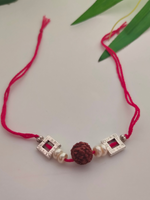 Load image into Gallery viewer, Rudraksha Bead, White Beads and Metal Rakhi with Cotton Thread
