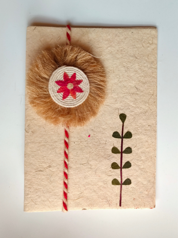 Eco-Friendly Handmade Jute Flower Rakhi with Dried Leaves and Flower Petals (Comes with a Reusable Cloth Pouch and Recycled Paper Card)