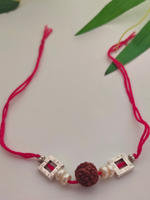 Load image into Gallery viewer, Rudraksha Bead, White Beads and Metal Rakhi with Cotton Thread
