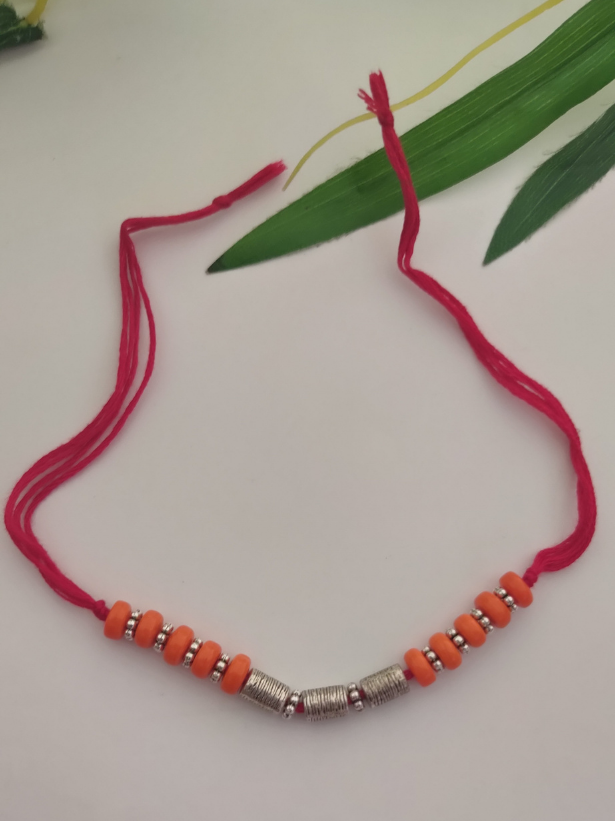 Orange Wooden Beads and Metal Beads Rakhi with Pink Cotton Thread