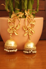 Load image into Gallery viewer, Leaf Motifs Gold Toned Brass Dangler Jhumka Earrings Accentuated with White Beads
