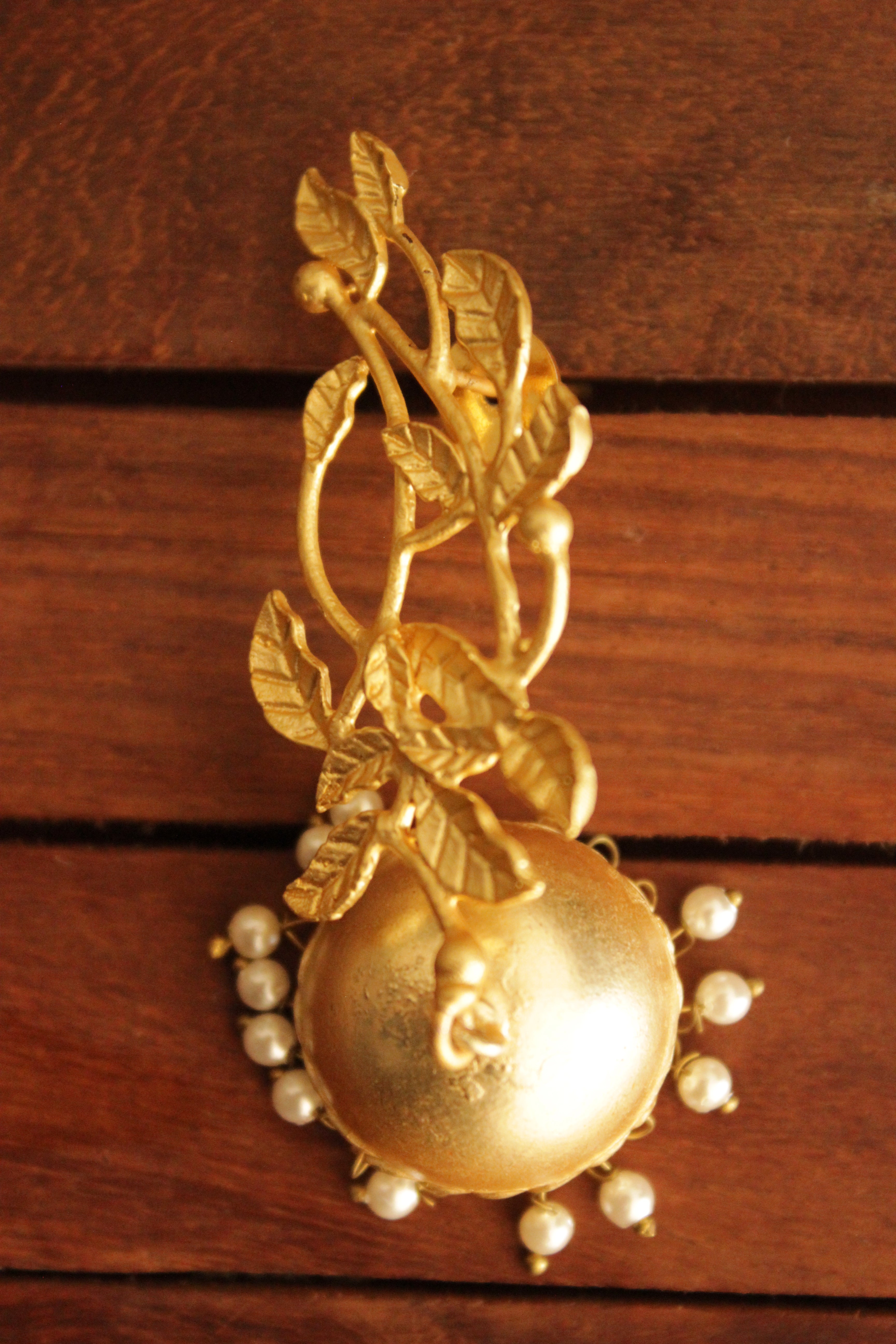 Leaf Motifs Gold Toned Brass Dangler Jhumka Earrings Accentuated with White Beads