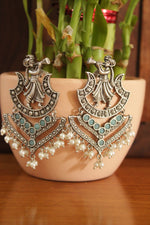 Load image into Gallery viewer, Turquoise Glass Stones Embedded Wedding Shehnai Motif Oxidised Finish Brass Earrings
