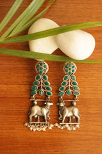 Load image into Gallery viewer, Green Glass Stones Embedded Cow Motif Oxidised Finish Brass Dangler Earrings
