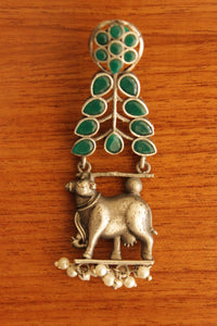 Green Glass Stones Embedded Cow Motif Oxidised Finish Brass Dangler Earrings