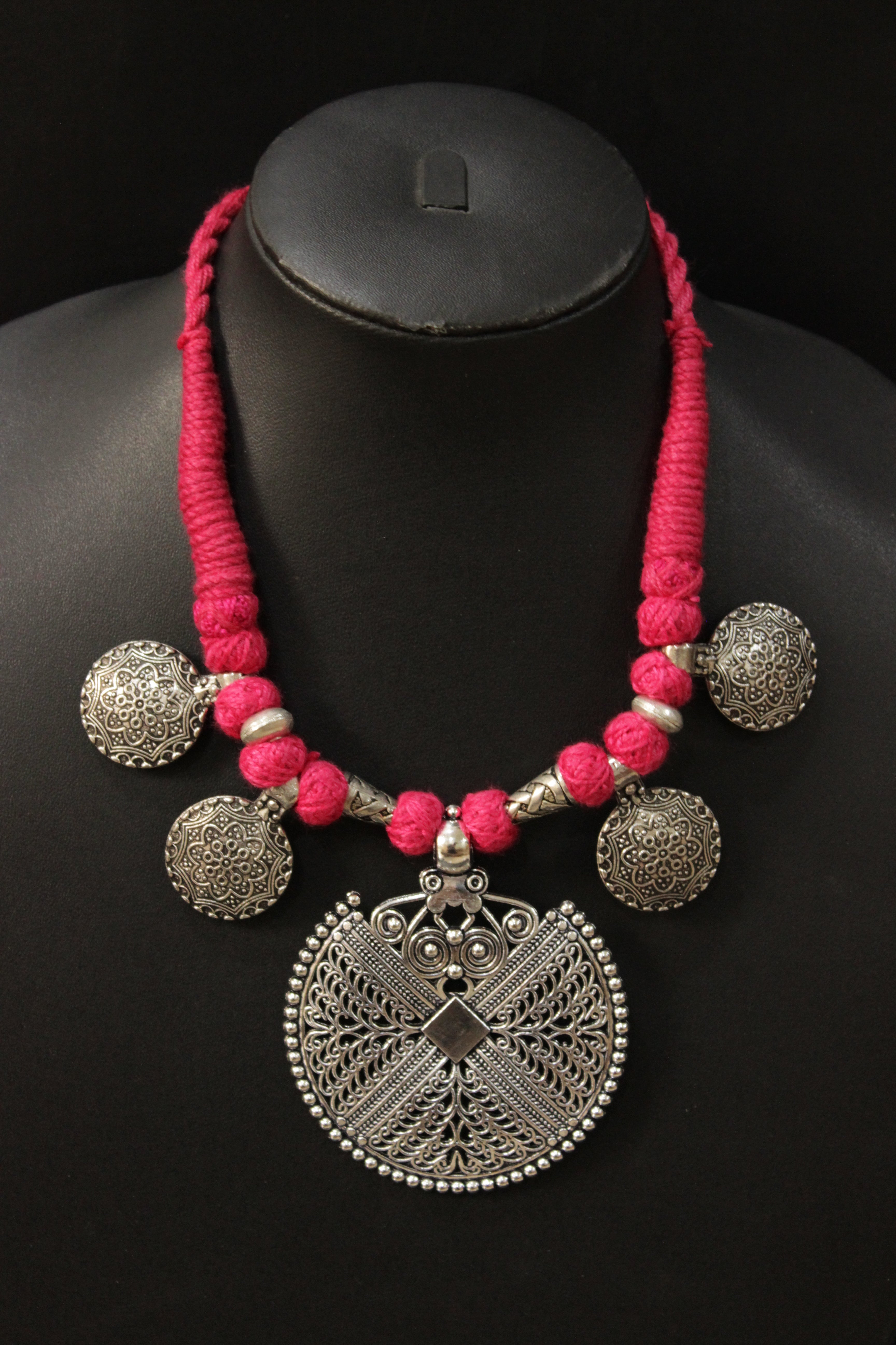 Intricately Detailed Metal Pendant and Charms Pink Thread Braided Necklace