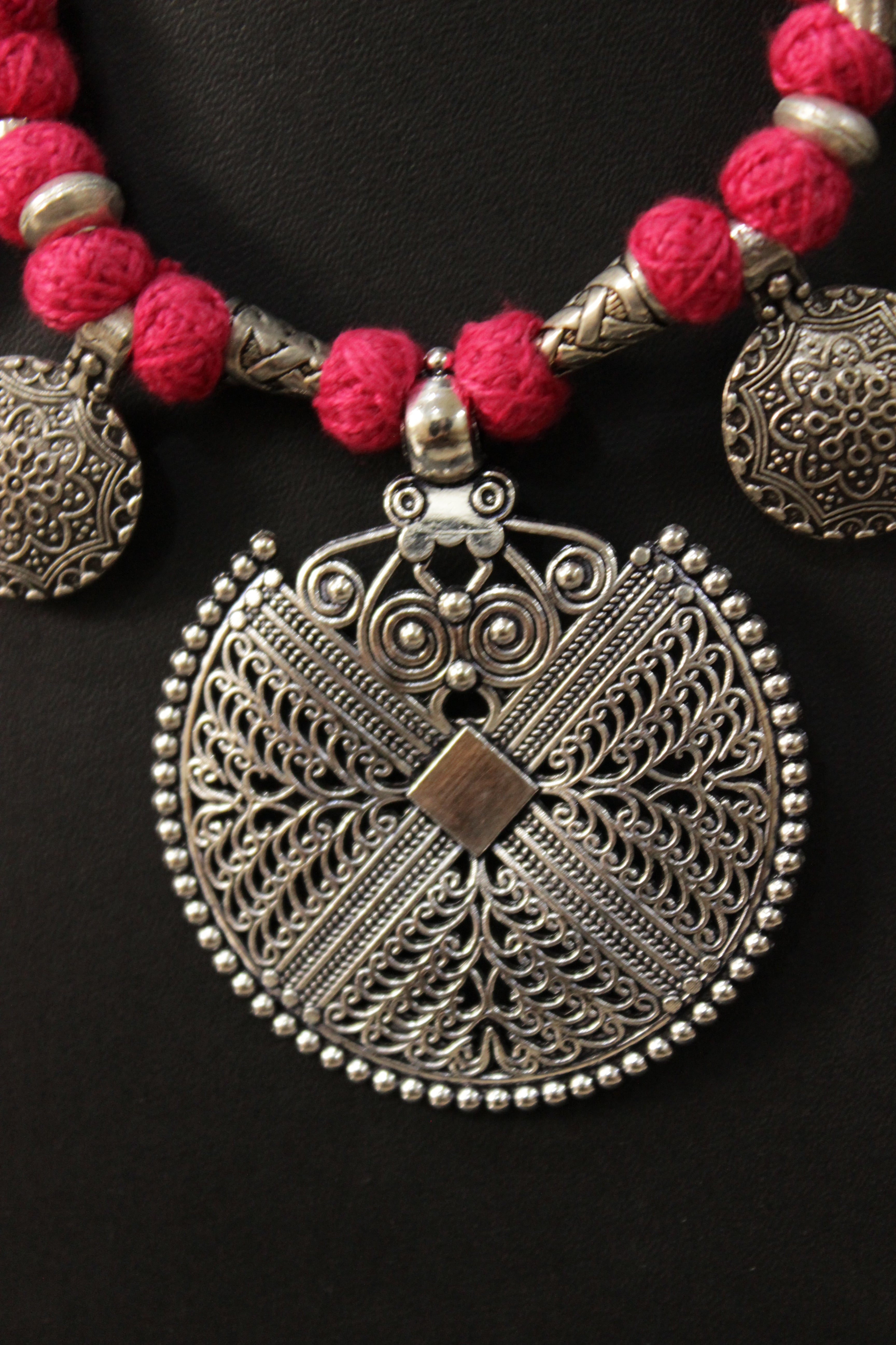 Intricately Detailed Metal Pendant and Charms Pink Thread Braided Necklace