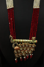 Load image into Gallery viewer, Kundan Stones Embedded Enamel Painted Peacock and Bansuri Motif Pendant Multi-Layer Red Beads Necklace Set
