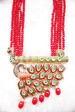 Load image into Gallery viewer, Kundan Stones Embedded Enamel Painted Peacock and Bansuri Motif Pendant Multi-Layer Red Beads Necklace Set
