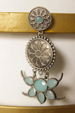 Load image into Gallery viewer, Turquoise Natural Gemstones Embedded Oxidised Finish Flower Brass Jhumka Earrings

