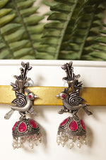 Load image into Gallery viewer, Fuchsia Glass Stones Embedded Bird Motif Oxidised Finish Dangler Jhumka Earrings
