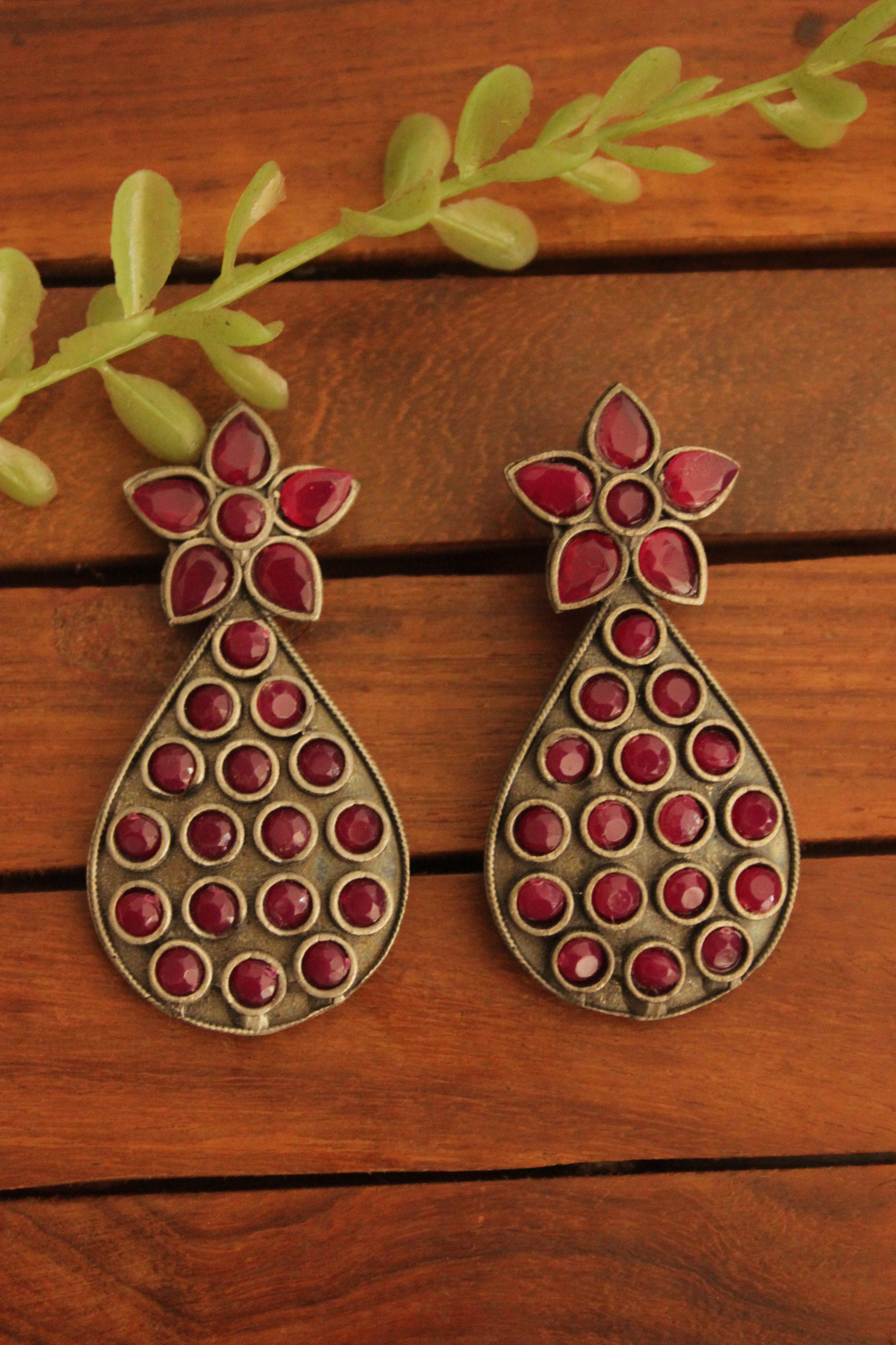 Oxidised Finish Flower Motif Teardrop Earrings Embedded with Ruby Red Stones