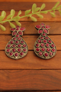 Oxidised Finish Flower Motif Teardrop Earrings Embedded with Ruby Red Stones