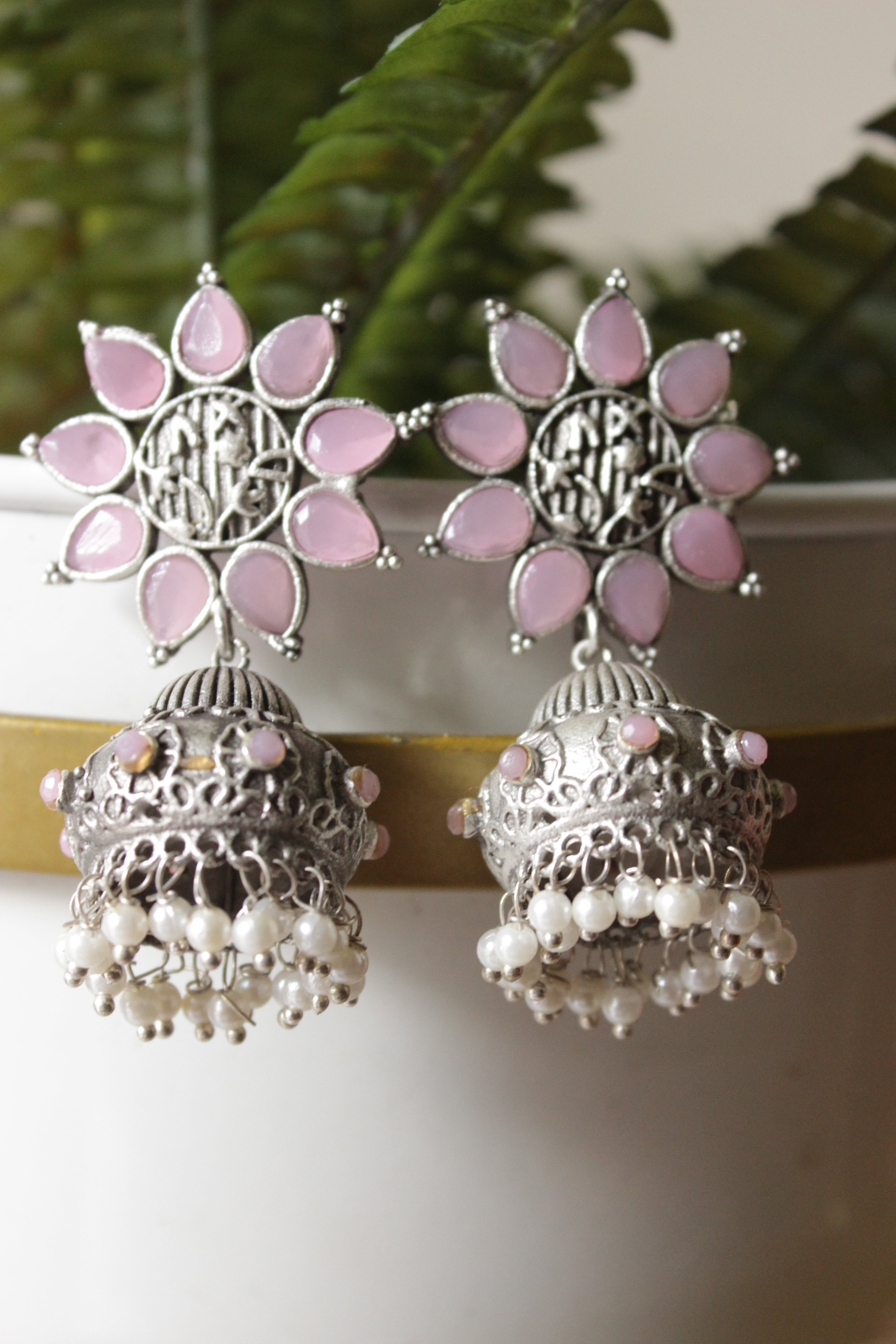 Baby Pink Glass Stones Embedded Silver Finish Flower Motif Dangler Jhumka Earrings in Brass