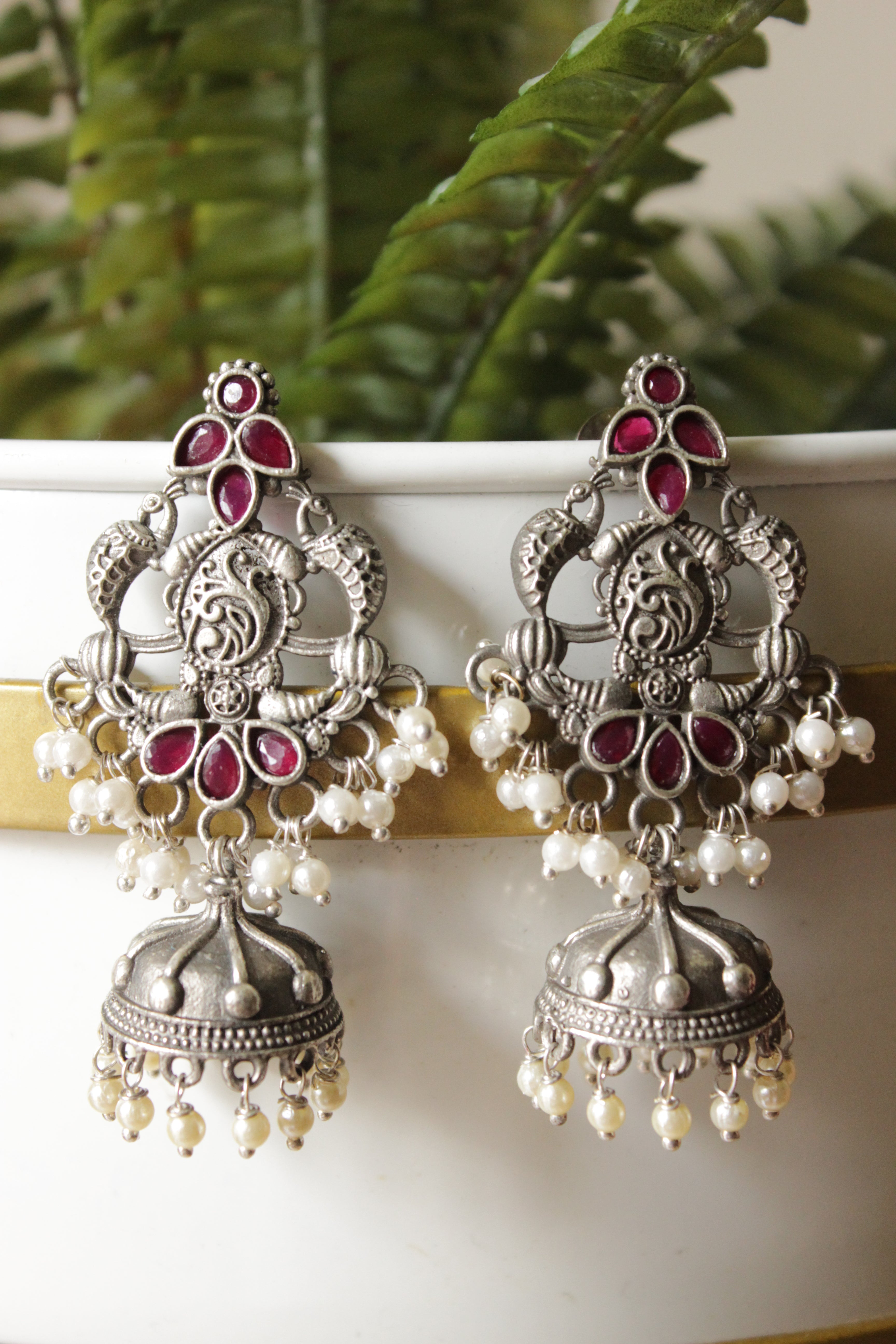 Intricately Detailed Red Glass Stones Embedded Brass Statement Dangler Earrings Accentuated with White Beads