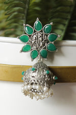 Load image into Gallery viewer, Bottle Green Glass Stones Embedded Silver Finish Flower Motif Dangler Jhumka Earrings in Brass
