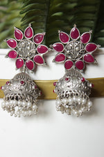Load image into Gallery viewer, Bridal Plum Glass Stones Embedded Silver Finish Flower Motif Dangler Jhumka Earrings in Brass
