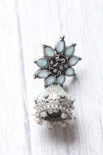 Load image into Gallery viewer, Turquoise Glass Stones Embedded Silver Finish Flower Motif Dangler Jhumka Earrings in Brass
