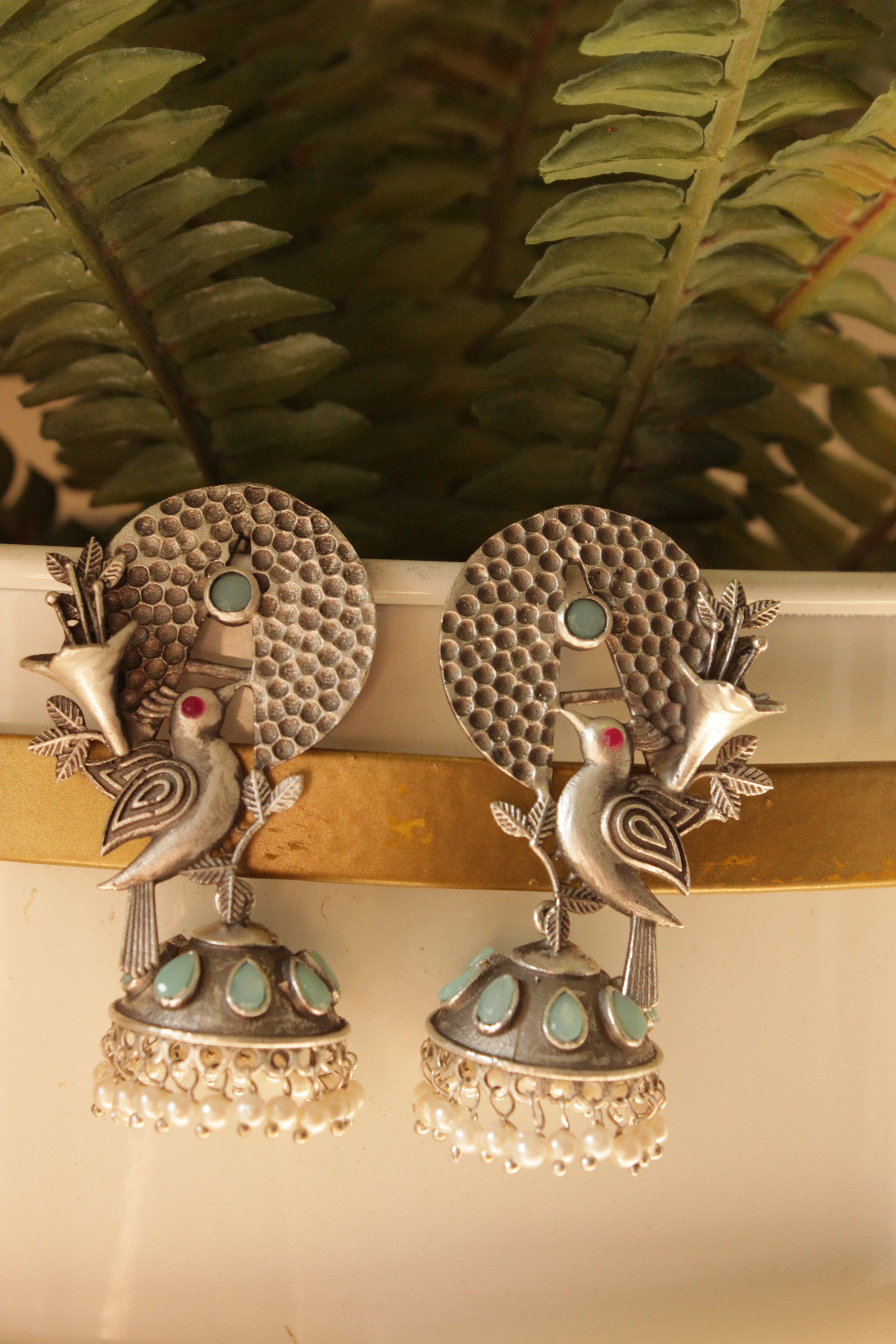 Turquoise Stones Embedded Silver Finish Peacock Motif Statement Dangler Earrings Accentuated with White Beads