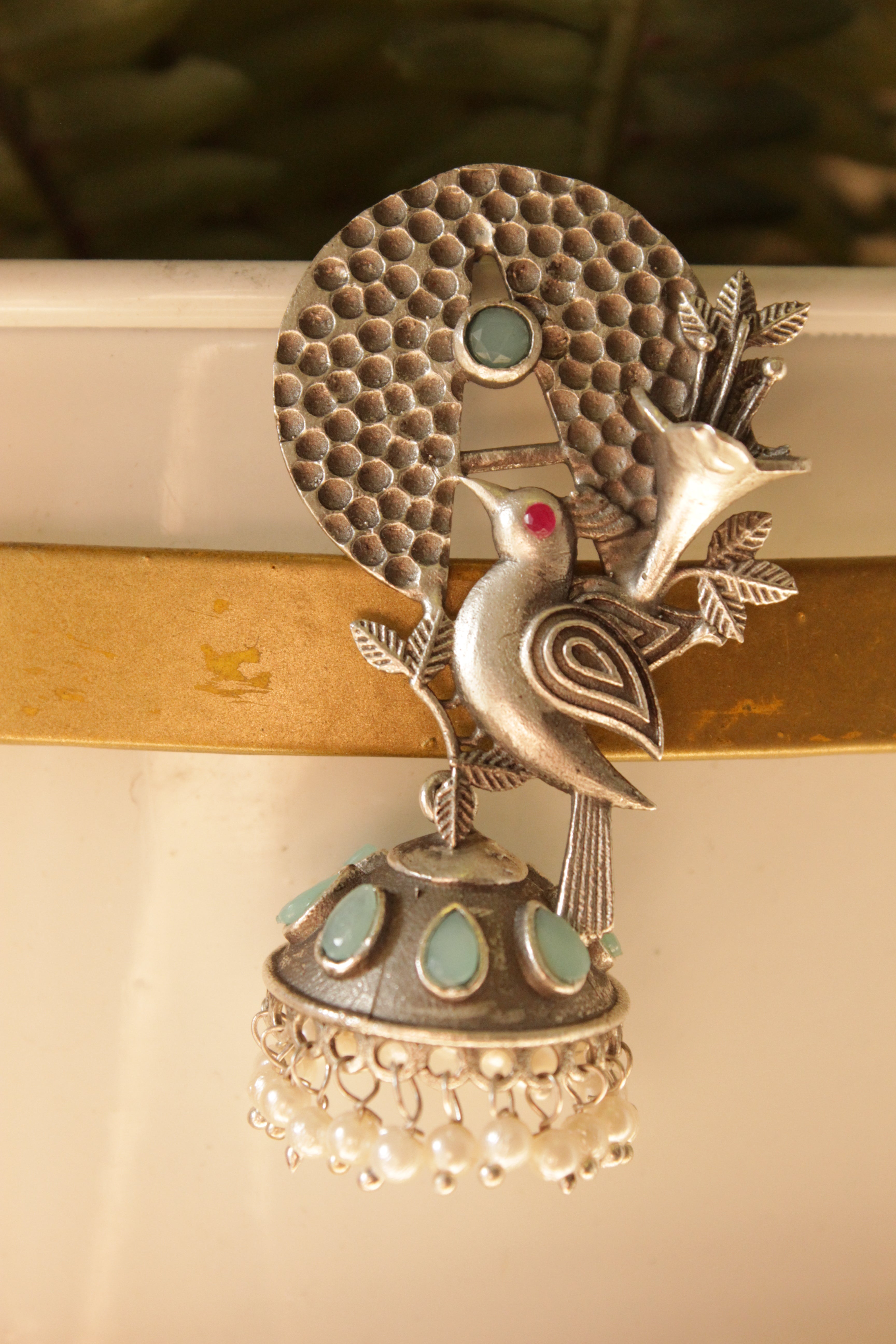 Turquoise Stones Embedded Silver Finish Peacock Motif Statement Dangler Earrings Accentuated with White Beads