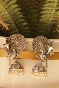 Pink Stones Embedded Silver Finish Peacock Motif Statement Dangler Earrings Accentuated with White Beads