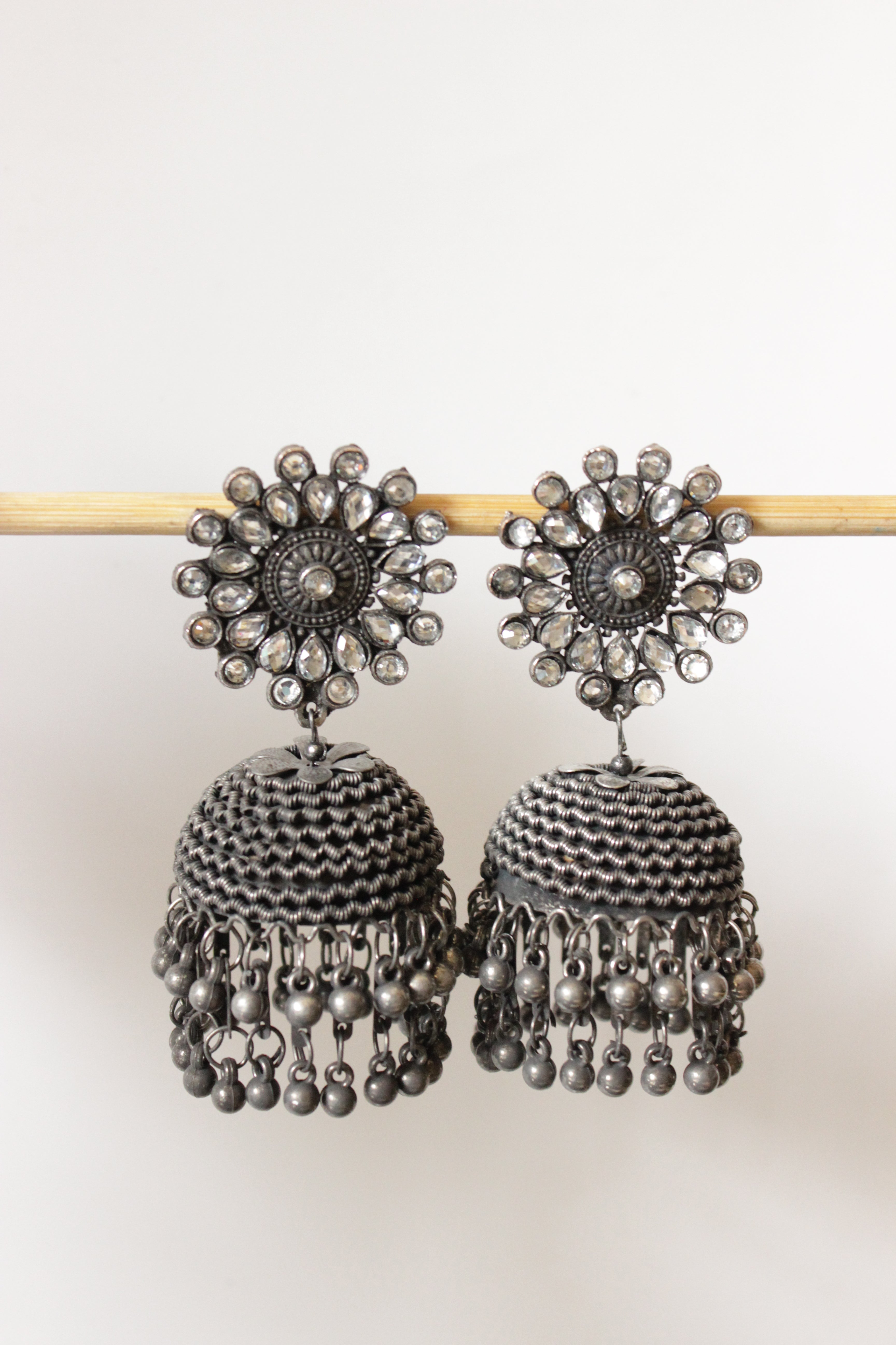 White Glass Stones Embedded Oxidised Finish Jhumkas with Bead Strings
