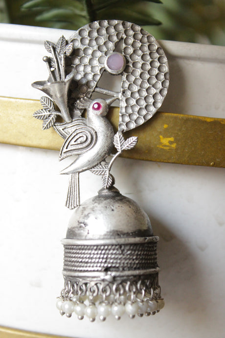 Pink & Red Stones Embedded Silver Finish Peacock Motif Statement Jhumka Earrings Accentuated with White Beads